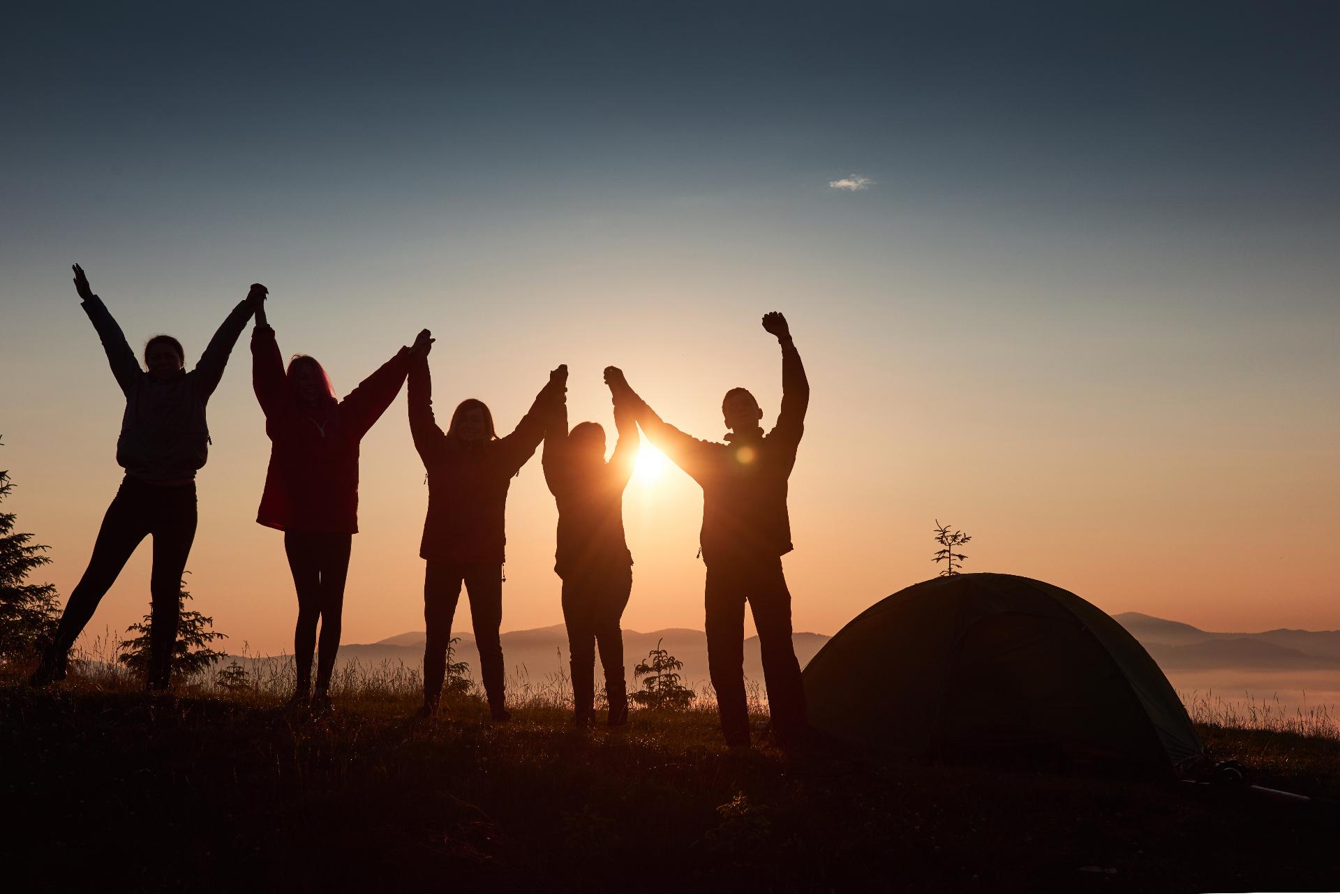 Silhouette Group People Have Fun Top Mountain Near Tent During Sunset